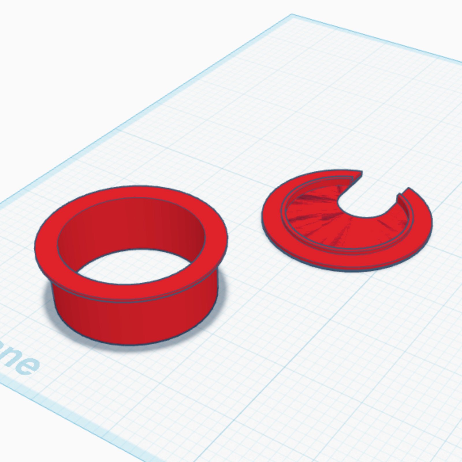 Digital 3D model of a red two-part desk grommet: a flanged sleeve and a cap with a cable notch.